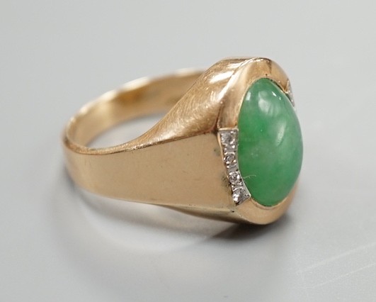 A 14k, cabochon jade and diamond chip set dress ring, size R/S, gross 7.6 grams.